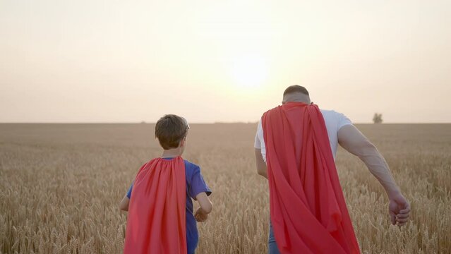 Father man son boy superman. Parent dad having fun to play with little kid child son in happy family activity lifestyle together summer day wheat field sunset, Concept win success winner hero victory