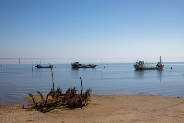 Fototapeta na wymiar oysters farm coast and boat at low tide in lege village of Arcachon bay cap ferret