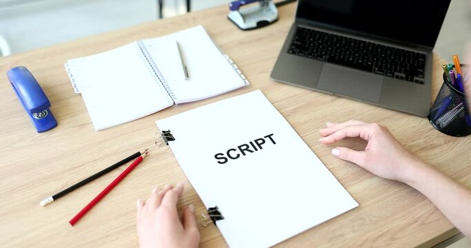 Woman hands hold and read script over table closeup