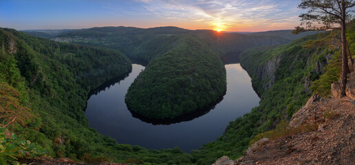 River canyon with water and summer green forest at sunset. Horseshoe bend, Vltava river, Czech republic. Beautiful landscape with river at sunset.