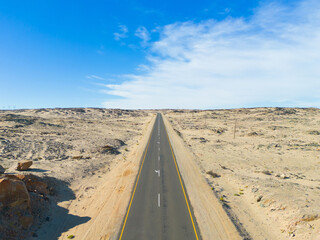 Aerial top view of street road Namib Desert Safari with sand dune in Namibia, South Africa. Natural landscape background at sunset. Famous tourist attraction. Sand in Grand Canyon