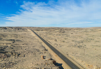 Aerial top view of street road Namib Desert Safari with sand dune in Namibia, South Africa. Natural landscape background at sunset. Famous tourist attraction. Sand in Grand Canyon