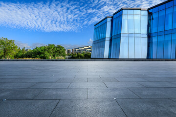 Empty square floor and glass wall with city skyline in Ningbo, Zhejiang Province, China.