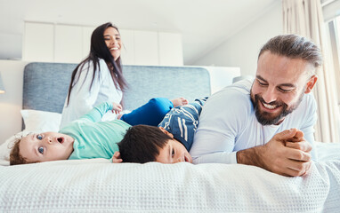 Happiness, smile and family being playful in the bedroom together of their modern house. Happy,...