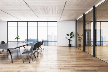 Side view on dark empty conference table and dark chairs around on wooden parquet floor in sunlit meeting area with city view background from big window and glass partitions. 3D rendering