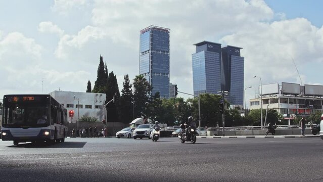 A busy city street with multiple cars driving by during the morning rush hour. The morning commute and the busy traffic of the city. A bustling street during rush hour, showing multiple cars. Israel