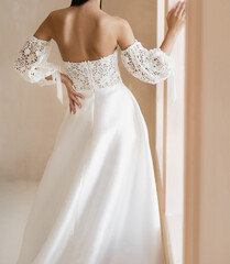 Beautiful brunet bride dressed in white long wedding dress with the naked back. Gorgeous wedding...