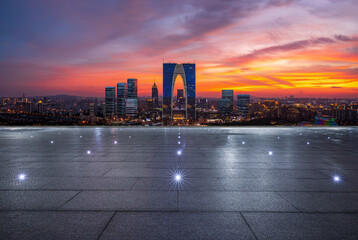 Empty floor and city skyline with modern building at sunset in Suzhou, China.