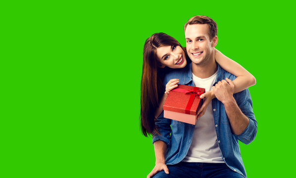 Love, relationship, dating, flirting, lovers, romantic concept - happy couple holding red gift box, isolated green chroma key background.