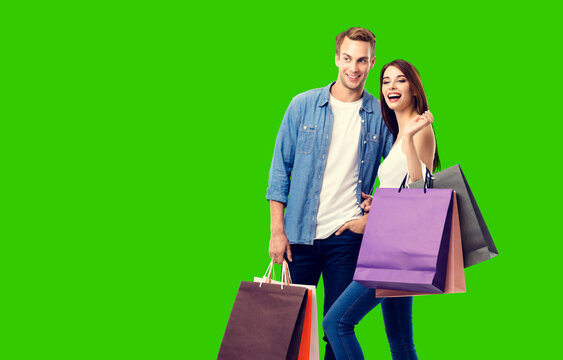 Love, Holiday Sales, Shop, Retail, Consumer Concept - Happy Excited Laughing Couple With Shopping Bags, Isolated Green Chroma Key Background.