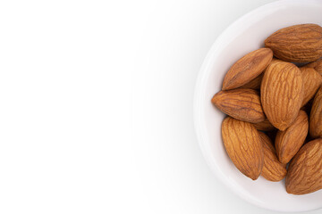 Beautiful big raw peeled almonds laying in the small bowl on  white background. View close to object with copyspace.  Side copy space for text. Horizontal Orientation. Healthy food concept. png