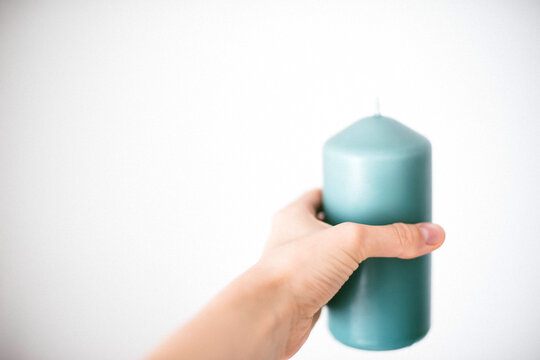 Woman holding candle in hand.