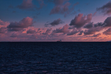 Seascape at sunset with a ship in the ocean. Toned.