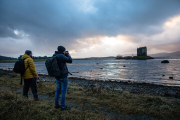 Man shooting pictures of a castle in Scotland