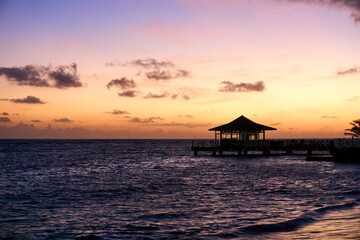 beautiful sunset on the sea with a pavilion in the foreground