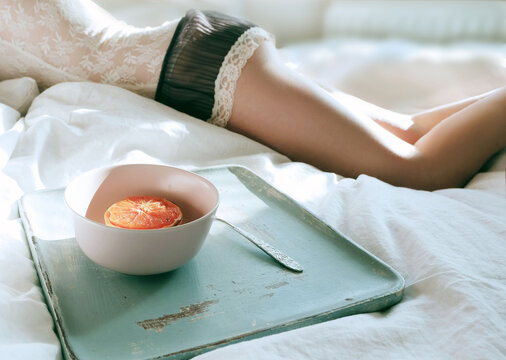 Grapefruit breakfast in bed with morning light