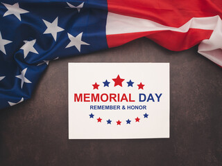 Part of the American flag and a text Memorial Day on a white paper on a vintage background