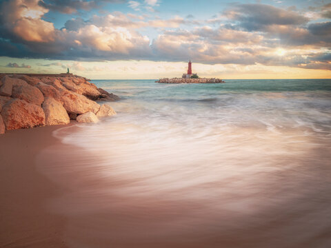 Sun rays over the lighthouse of Villajoyosa beach