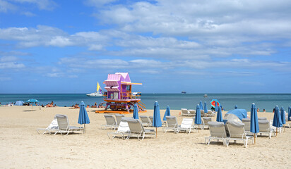 Paradise. Lifeguard Tower and sandy beach with sun loungers and umbrellas at South Pointe. Miami Beach, Florida