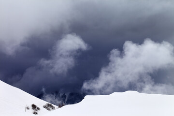 Off-piste slope and storm gray clouds. Caucasus Mountains, Georgia, ski resort Gudauri.