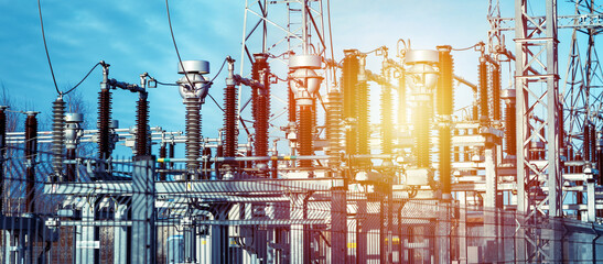 High voltage circuit breaker in a power substation.Electric power transmission lines in the...