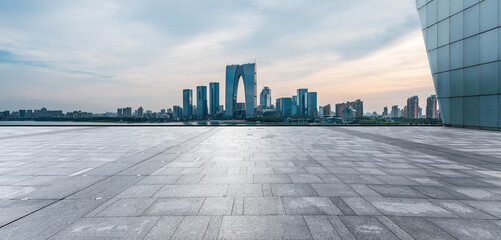 Panoramic view of city skyline and modern buildings with empty floor in Suzhou, China. - obrazy, fototapety, plakaty