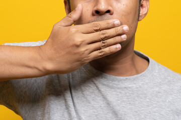 Fototapeta premium close-up crop view people using hand close covering his mouth to shut up.