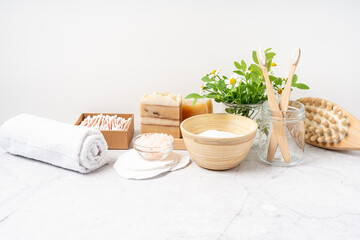 Natural bathroom and home spa tools. Zero waste sustainable lifestyle concept. Bamboo toothbrush, natural soap bar, cotton pads and swabs, homemade DIY beauty products on white background.