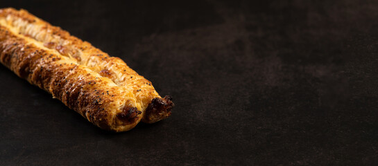 Sweet fresh pastry, puff, on dark background, close-up, place for text, banner