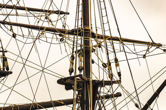 Image composed of a set of ropes and pulleys on an old 3 masts, on a white background. 