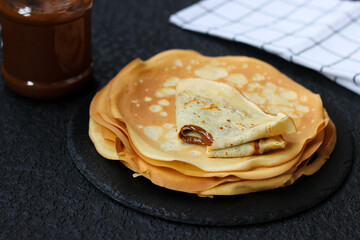 Super delicious crêpe filled with condensed milk, bitten