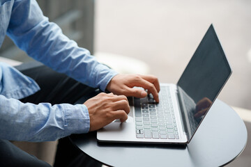 Fototapeta na wymiar Businessman sitting using laptop computer on table in office.