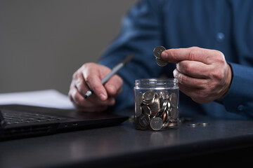 Fototapeta na wymiar Businessman's hand counting pennies