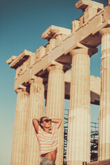 Happy girl tourist visits Acropolis. Greece