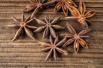 Dried star anise spice on vintage wooden board