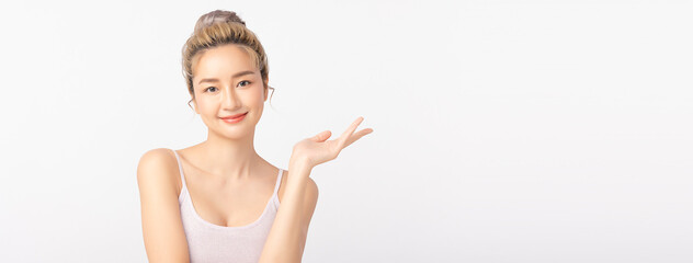 Panoramic happy beautiful asian woman showing empty copy space on the open hand. Asian girl beauty...