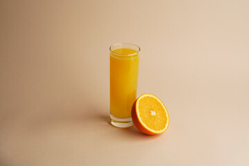 Glass of 100% Orange juice with sliced fruits