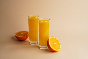 Glass of 100% Orange juice with sliced fruits