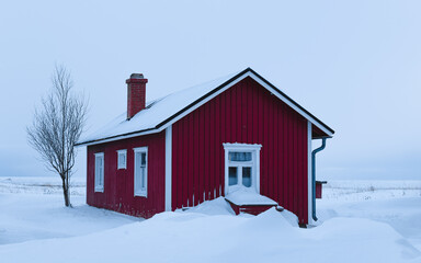 Red house in the snow on the island of Hailuoto, Finland