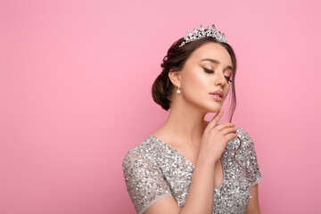 Beautiful young woman wearing luxurious tiara on pink background, space for text - Powered by Adobe
