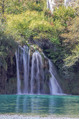 Waterfall coming out of the forest in the  Plitvice Lakes National Park