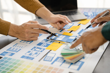 Creative digital development agency. developer team brainstorming on their project with laptop, smartphone and digital tablet.