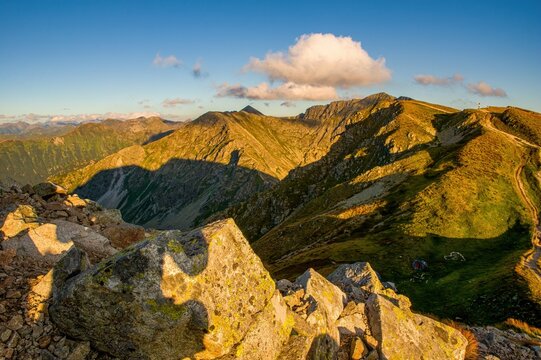 Sunrise from the ridge of the Western Tatras, Rohace with a view of the Salatin mountain with grass illuminated by the rising sun, camping and bivouac in nature. Tatras, tourist theme, tourist trail.