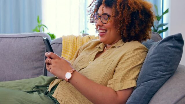 Phone, laughing and black woman on a sofa for social media, texting or funny meme in her home. Online, comic and girl relax with smartphone on couch, chatting or reading post or update in living room