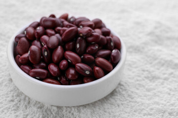 Brown seeds on kidney bean flour, closeup. Space for text