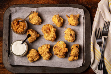 Cauliflower wings food. Pieces of cauliflower cooked in batter. Meat substitute, vegetarian food.