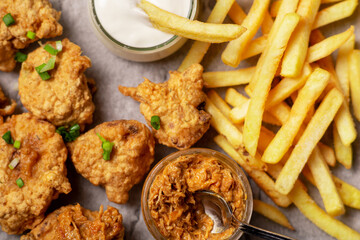Cauliflower wings food. Cauliflower pieces and french fries with vegan sauces. Vegetarian food.