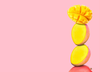 Stacked fresh mango fruits on light pink background, space for text
