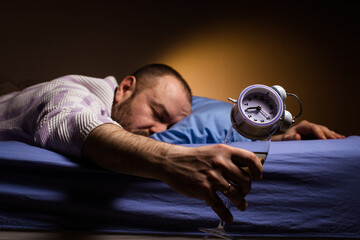 Man and alcoholism. Get drunk with alcohol and oversleep the alarm clock concept. Hangover agony in...