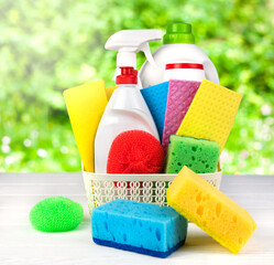 General spring cleaning. Different cleaning items and supplies on the wooden background. Close-up....
